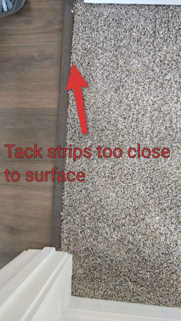 Exposed carpet tack strip safety concern found during a North Idaho inspection by AIM Home Solutions